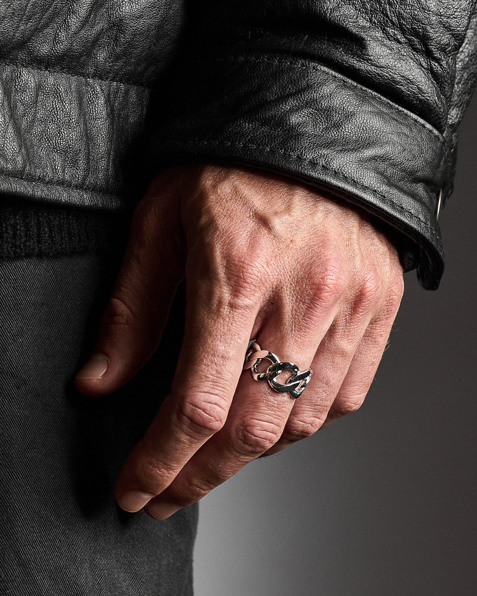 Cuban link ring worn on a model's hand, close-up detail