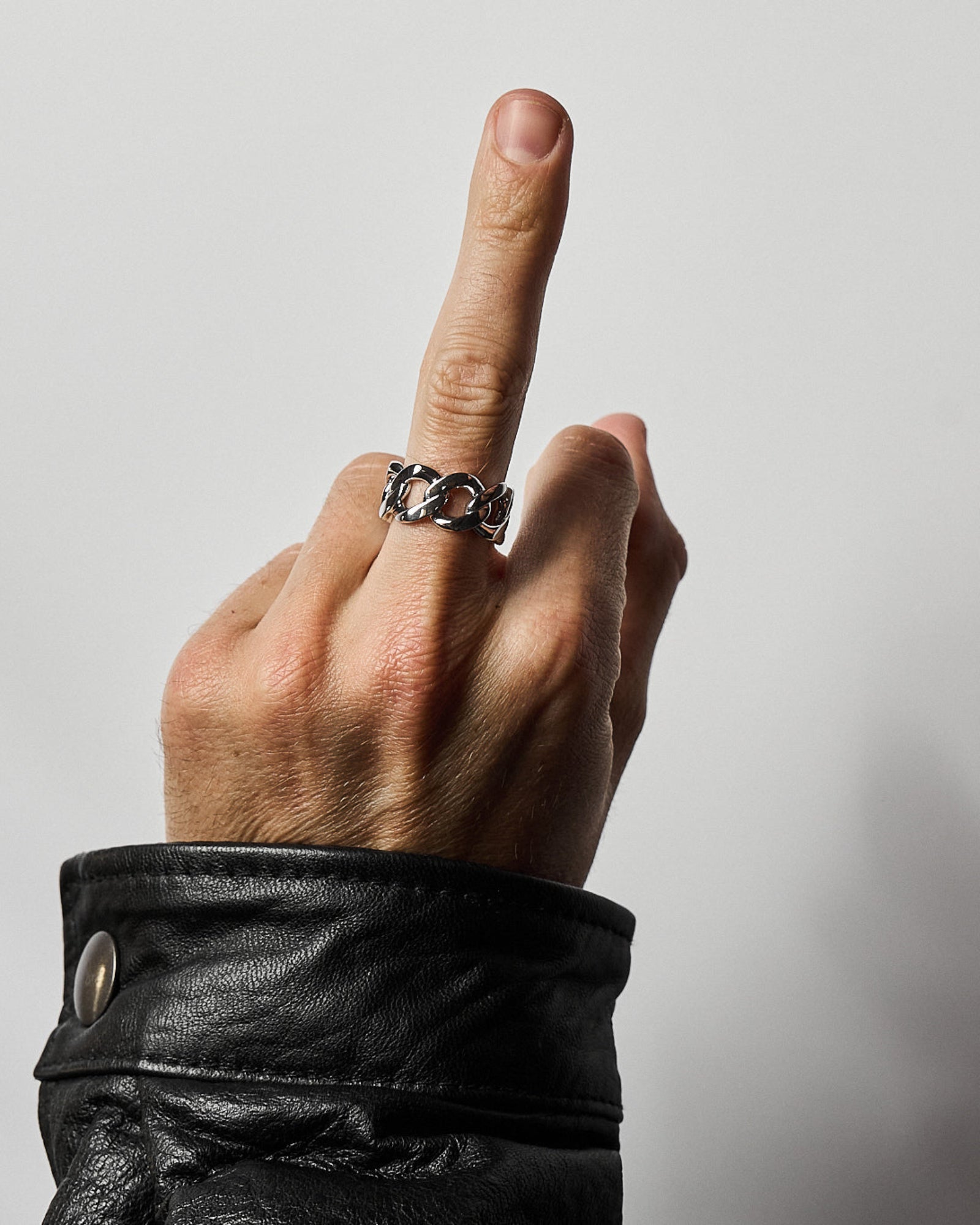 Cuban link ring worn on a model's hand, side profile