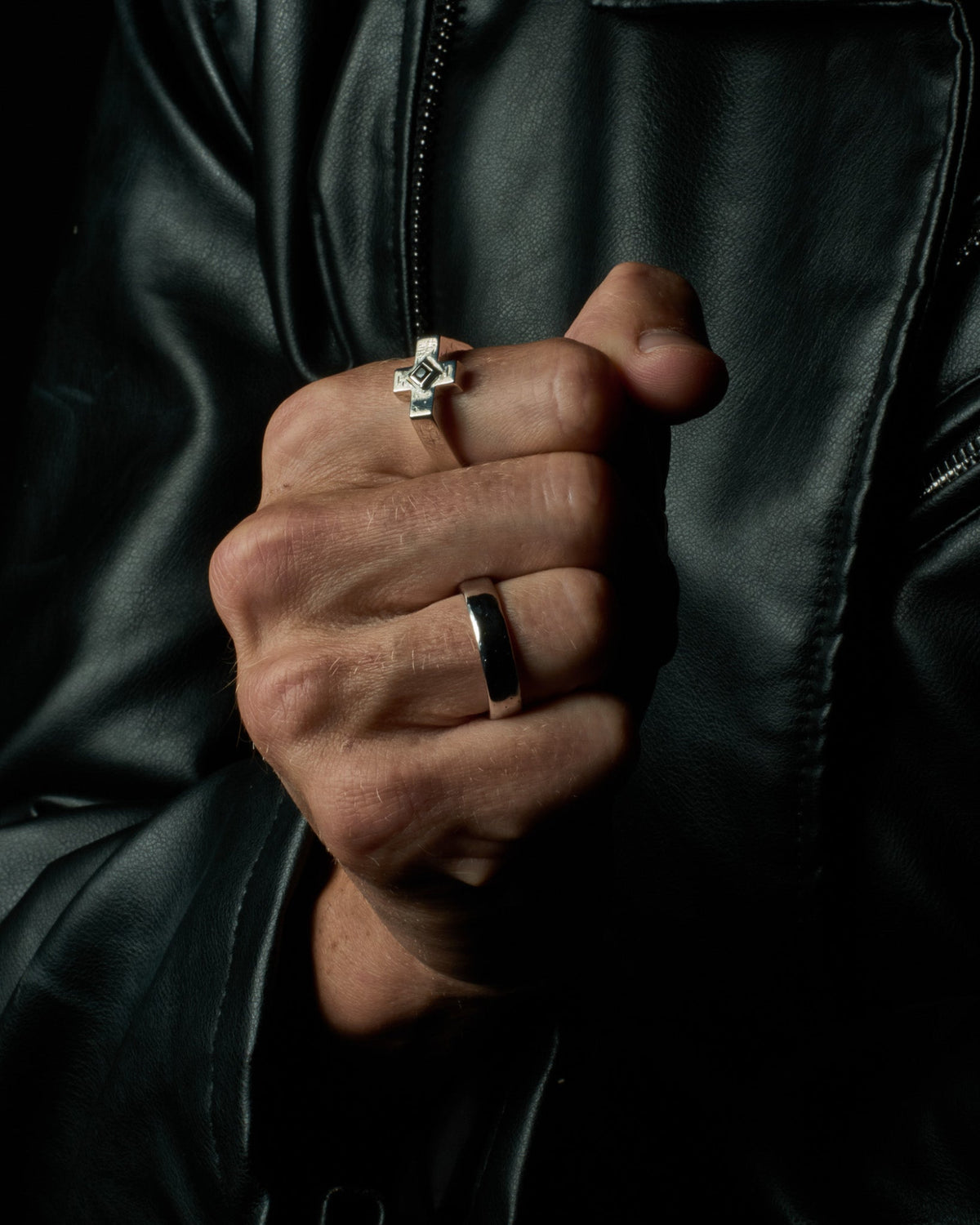 Model wearing the Raven Cross Ring handcrafted from solid 925 sterling silver featuring genuine black onyx.