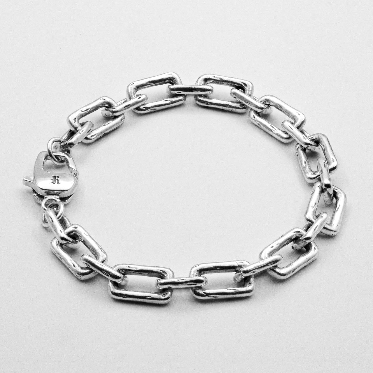 Curtis Bracelet showcasing varied chain links and hand-etched details