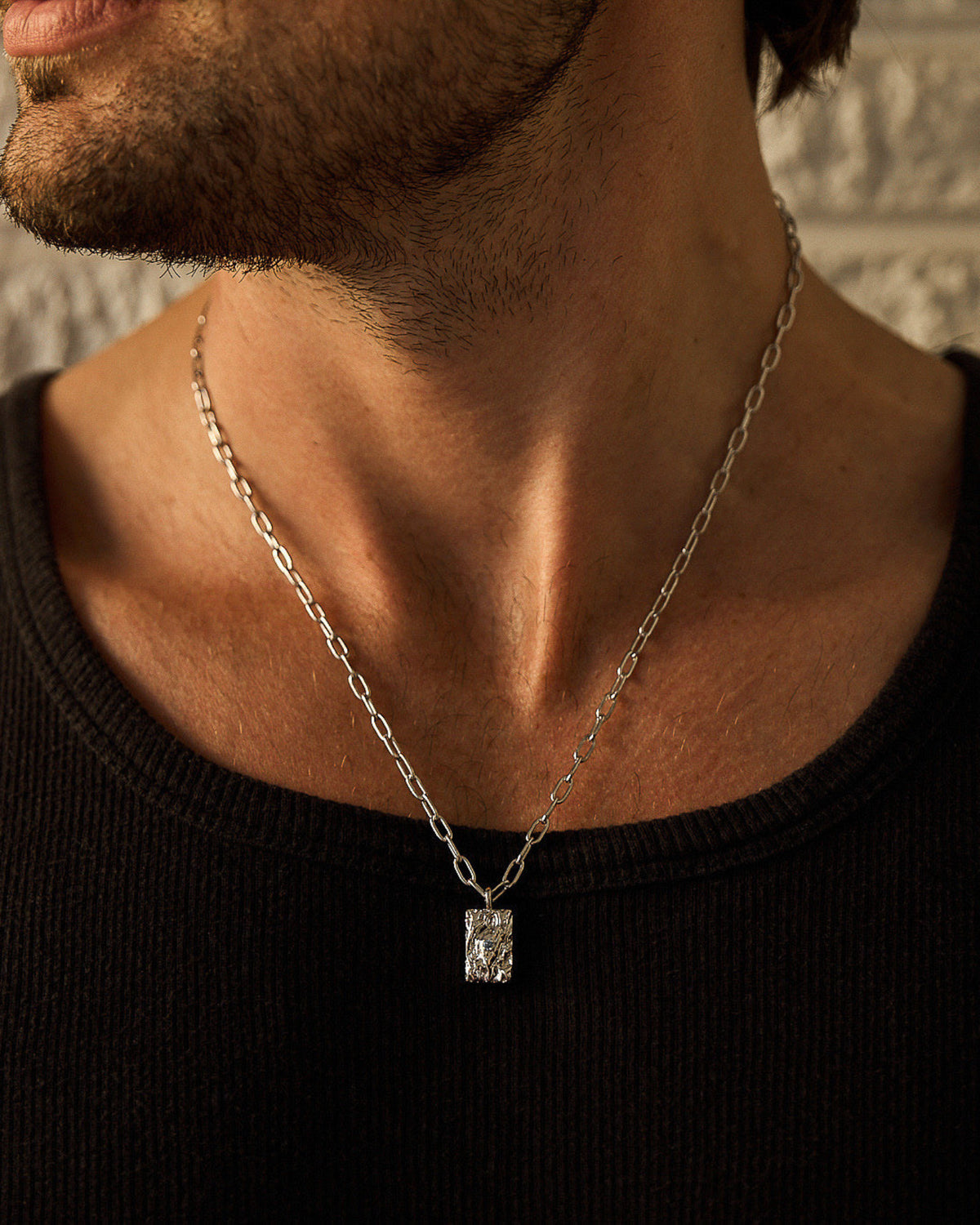 Rayne Pendant handcrafted from solid 925 sterling silver featuring an organic textured design and blue stone.