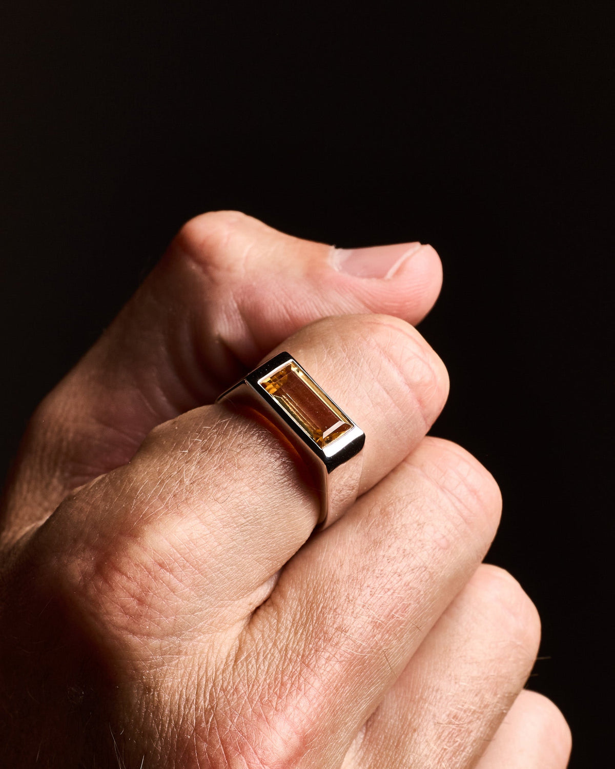 Model wearing the Sona Citrine Ring handcrafted from solid 925 sterling silver featuring a citrine-coloured stone.