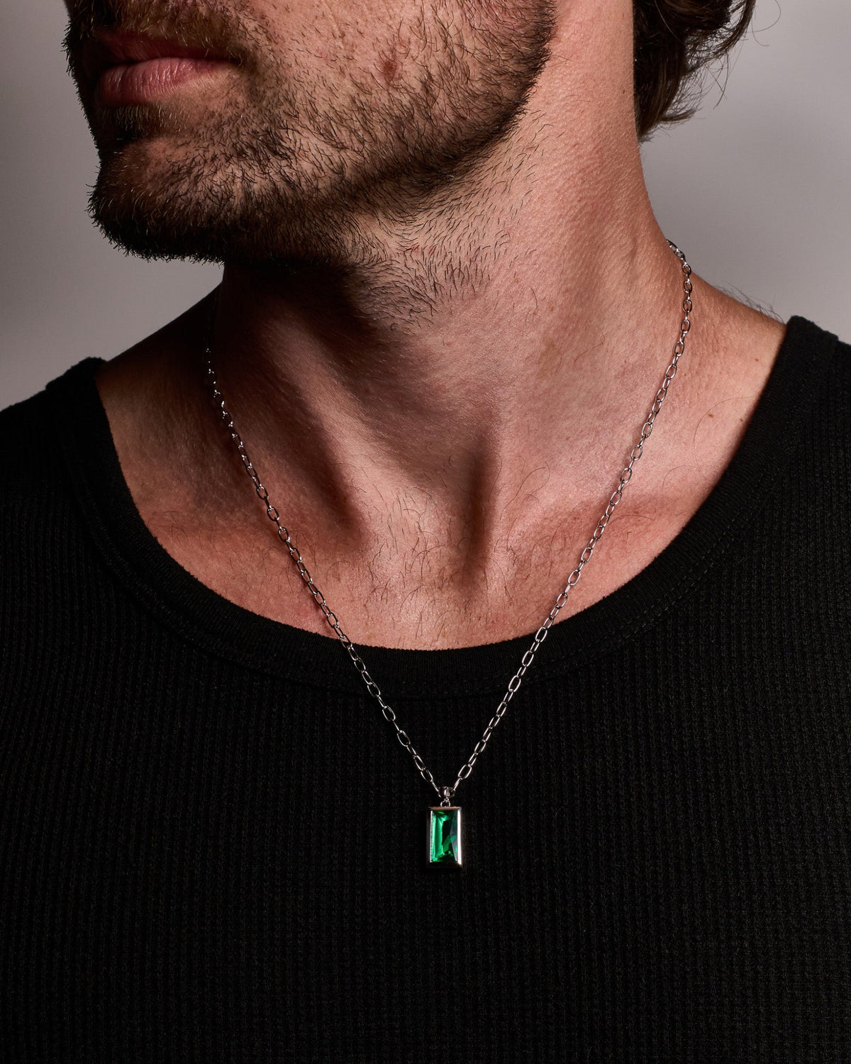 Model wearing the Sona Emerald Pendant handcrafted from solid 925 sterling silver on a sterling silver necklace.
