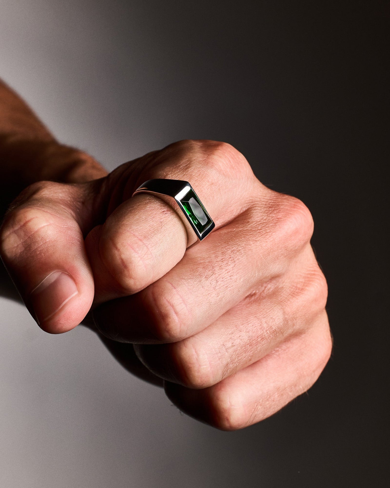 Sona emerald ring worn on a model's hand