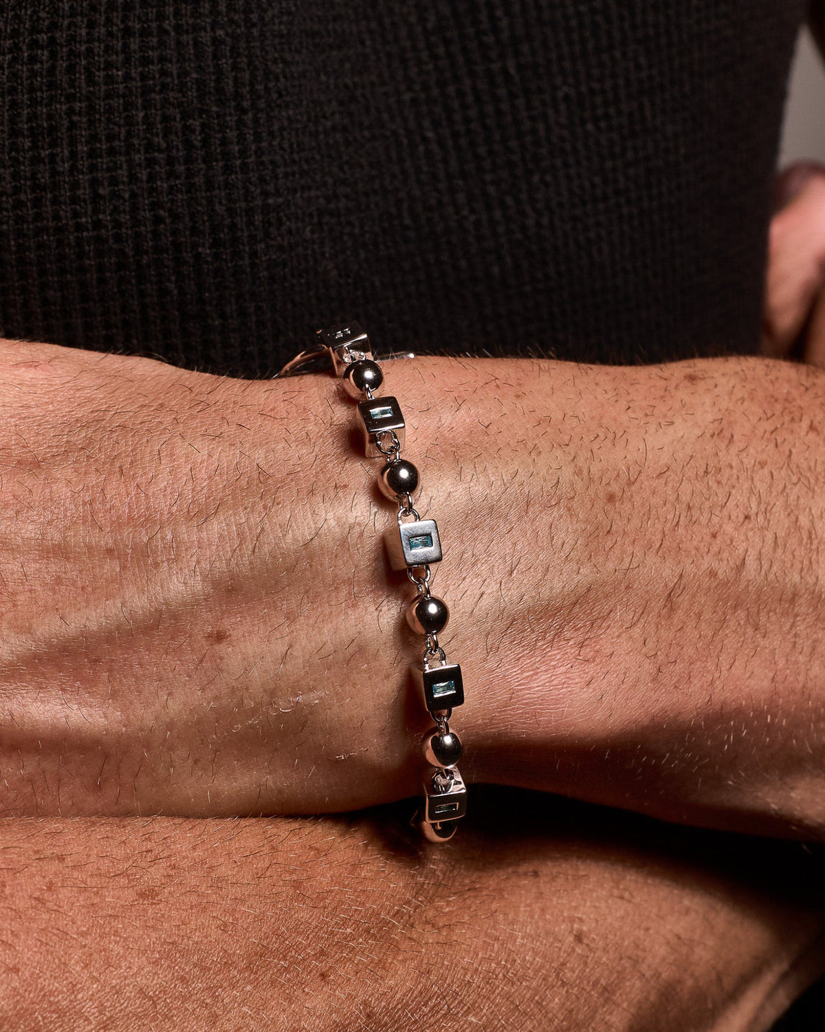 Close-up of the Topaz Bracelet featuring natural blue topaz gemstones and sterling silver links.